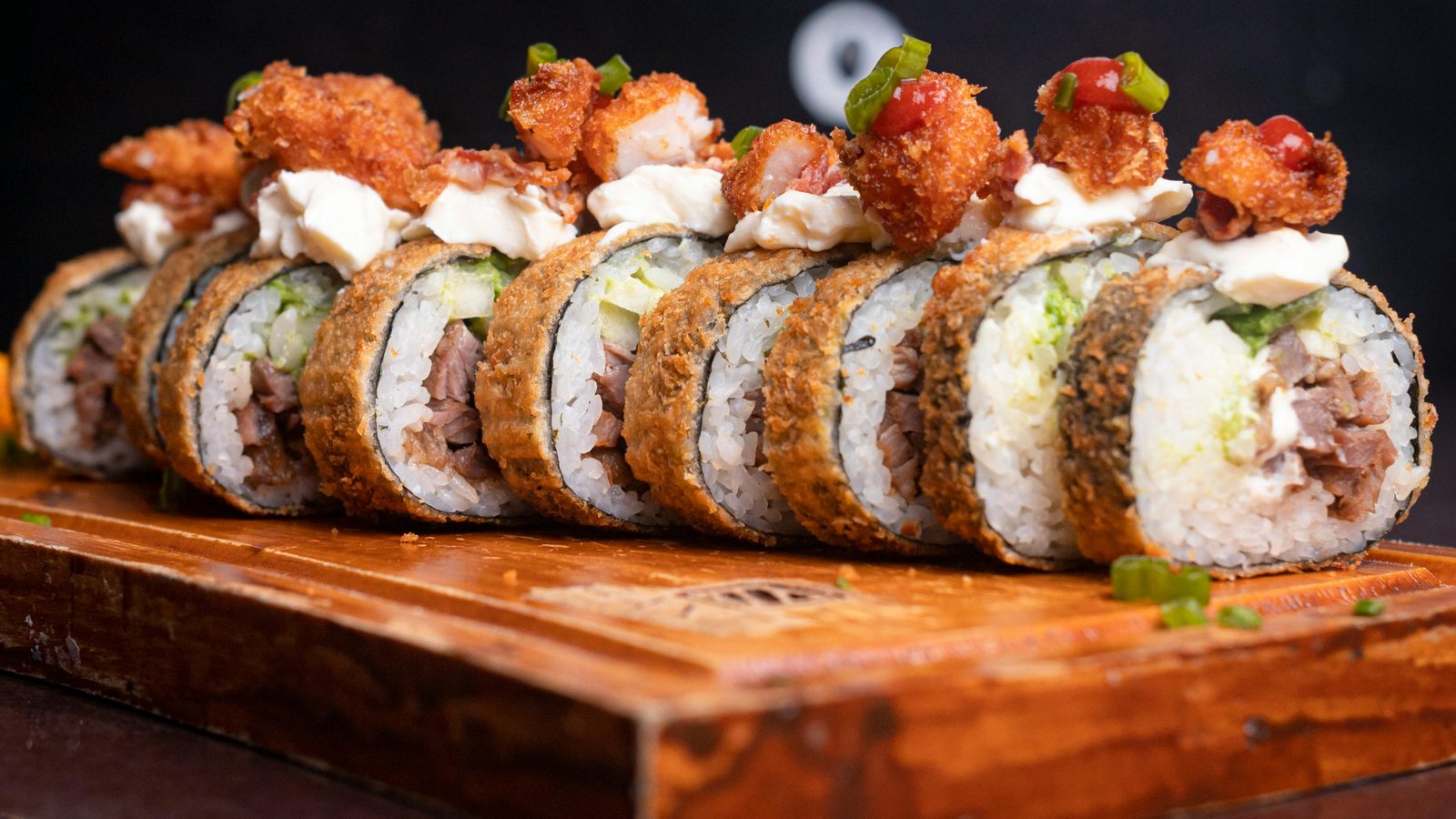 Crispy sushi rolls on a wooden board
